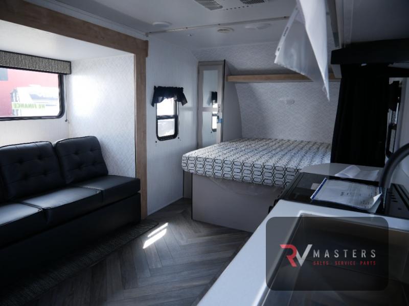 Heartland Prowler 205SRB interior with a bed, sofa, slide out, and kitchen