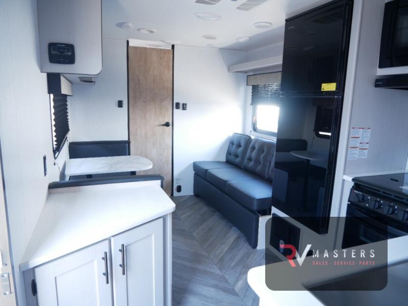 Heartland Prowler 240SRB interior with kitchen, dinette, sofa, and rear bathroom.